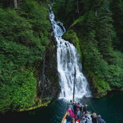 Alaska SS Legacy with waterfall Credit Uncruise