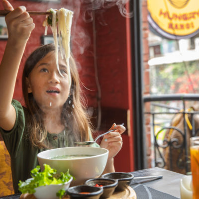 Vietnam Hanoi Hungry Hanoi Restaurant Girl Eating Pho Noodle Soup Credit G Adventures